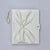 White leather booklet for gel color display booklet pouch with a knot on a light gray background