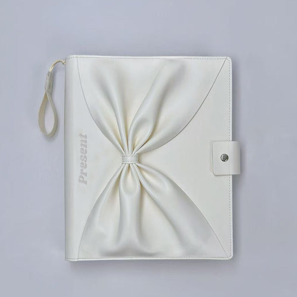 White leather booklet for gel color display booklet pouch with a knot on a light gray background