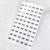 Sheet of numbered labels on a textured surface