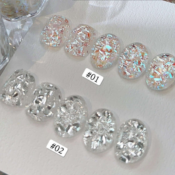Two trays of clear oval nail art stickers filled with iridescent glitter, labeled #01 and #02, displayed on a white surface with Chinese text overlay.