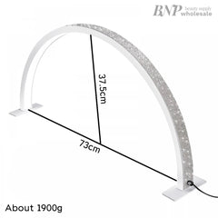 A white half moon-shaped LED lamp with a glittering surface, designed for nail/eyelash extension applications, with dimensions labeled.