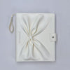 White leather booklet for gel color display booklet pouch with a knot on a light gray background