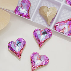 Heart-shaped crystal decorations on a light surface with a box in the background.