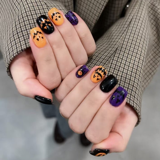 Collage of hands with Halloween-themed nail art on a blurred background