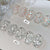 Two trays of clear oval nail art stickers filled with iridescent glitter, labeled #01 and #02, displayed on a white surface with Chinese text overlay.